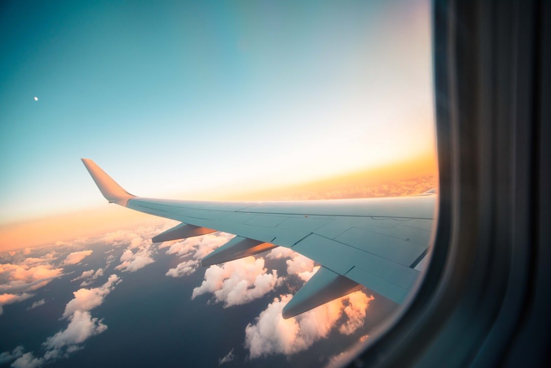 View from airplane window seat through clouds
