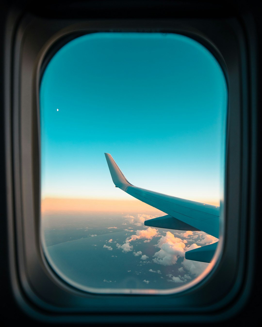Airplane wing against blue sky aerial view