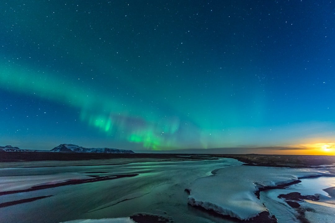 Northern Lights aurora over an Icelandic waterfall