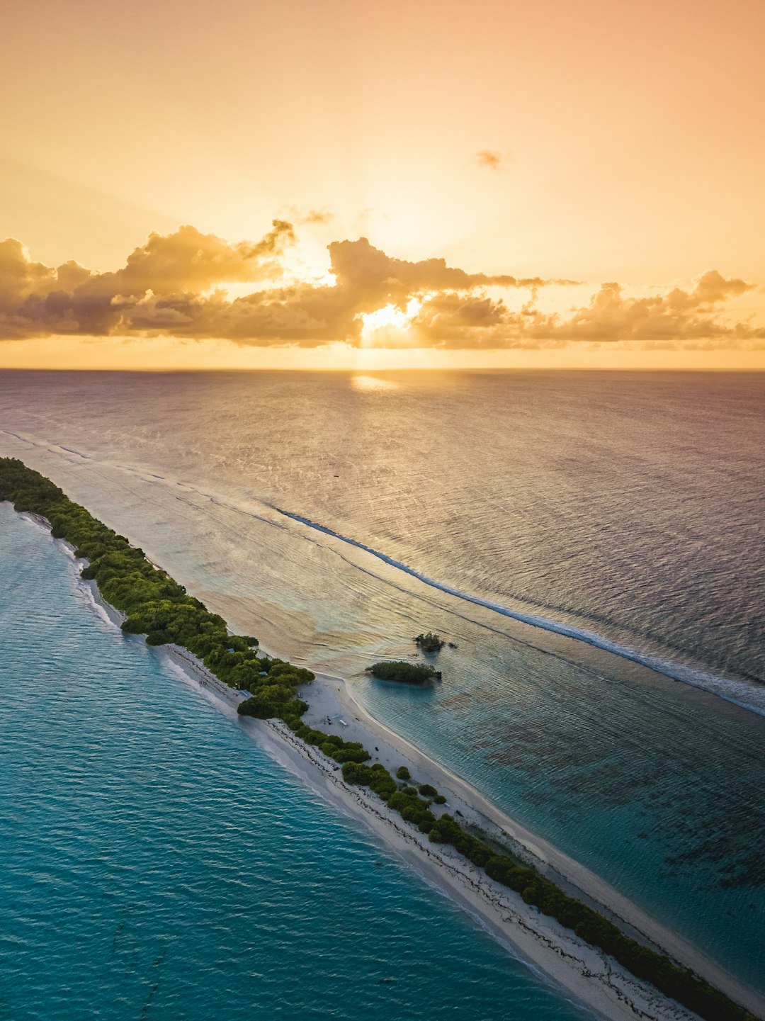 Golden sunset over the Maldives ocean horizon
