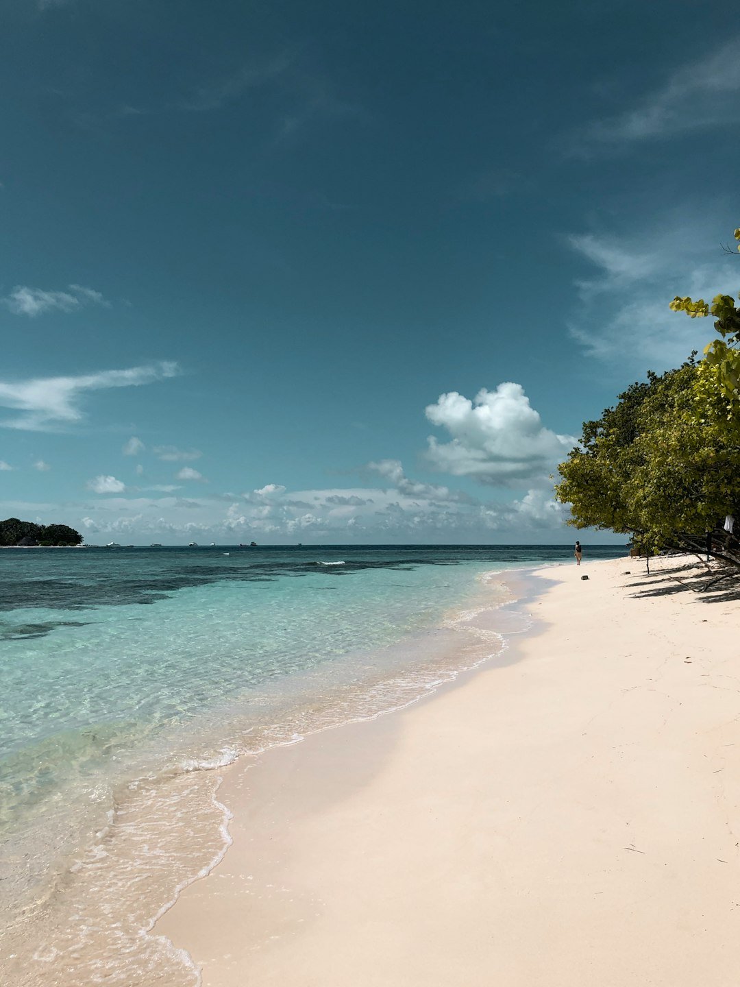 Pristine white sand beach and clear water in the Maldives