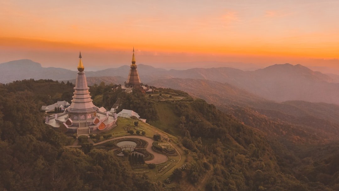 Chiang Mai temple with mountain backdrop in Thailand