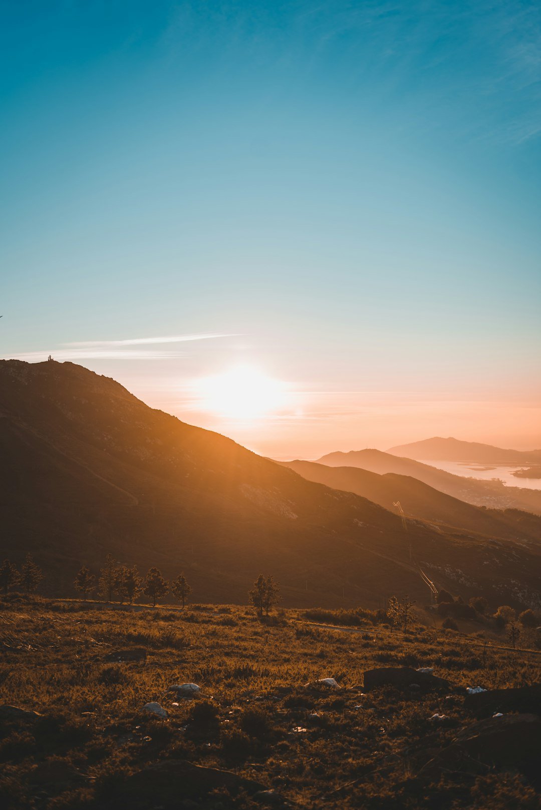Traveller watching sunset from mountain top