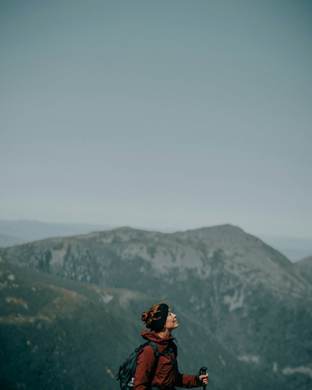 Woman solo backpacking and hiking in mountains